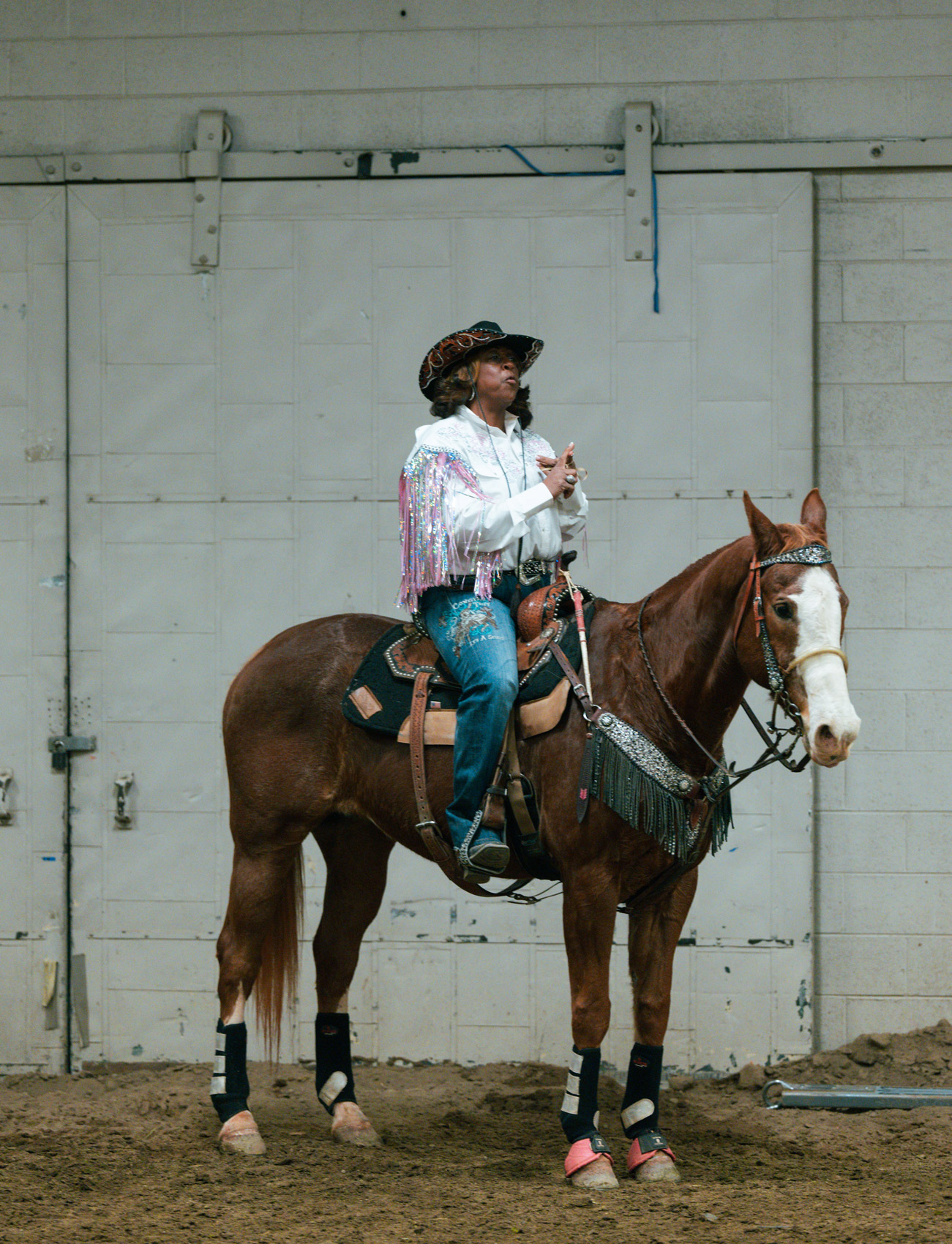 Cowgirl woman sitting on a horse