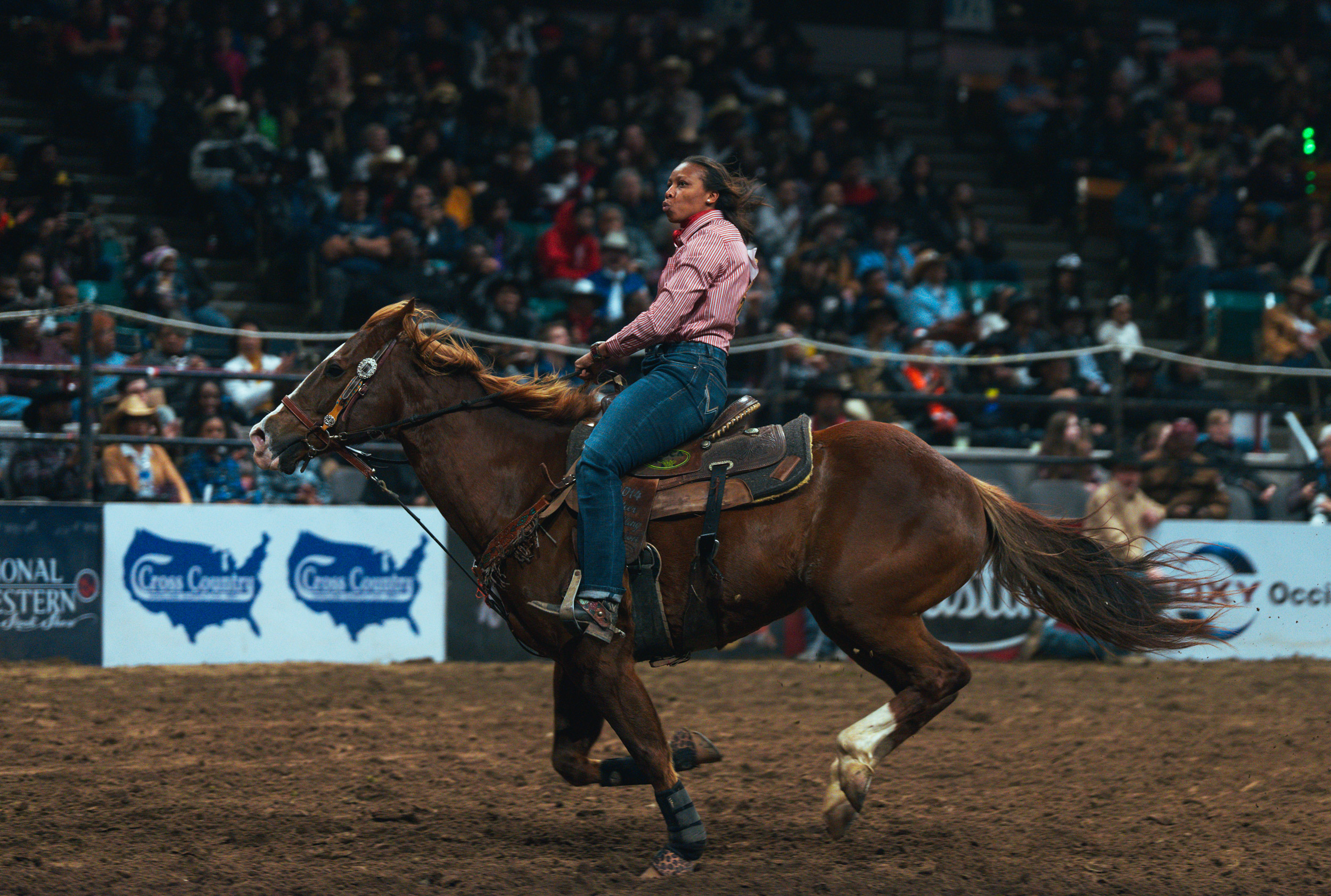 Woman riding horse rodeo at a competition