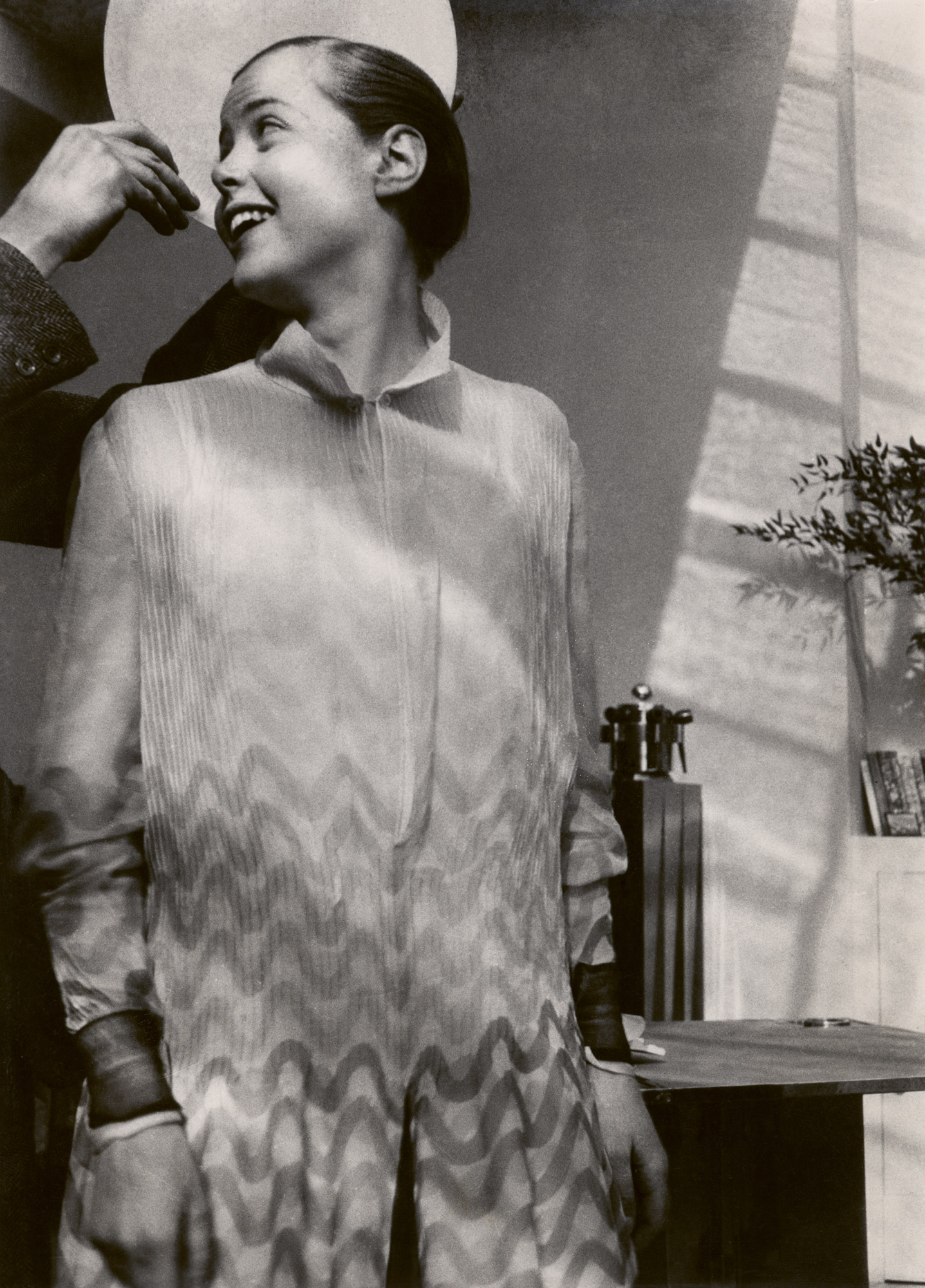 Charlotte Perriand laughing looking behind her
