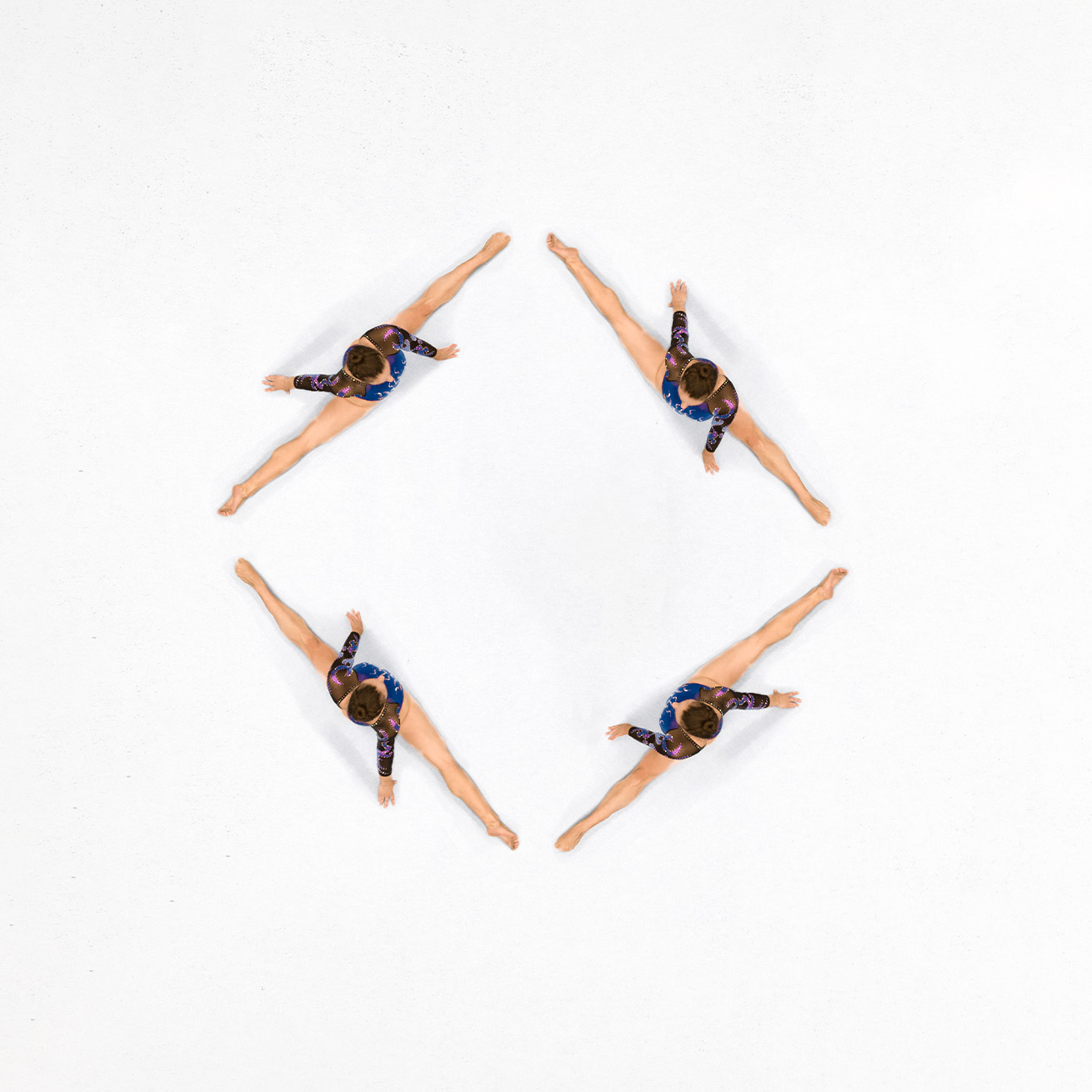 Aerial shot of four gymnasts in a diamond shape