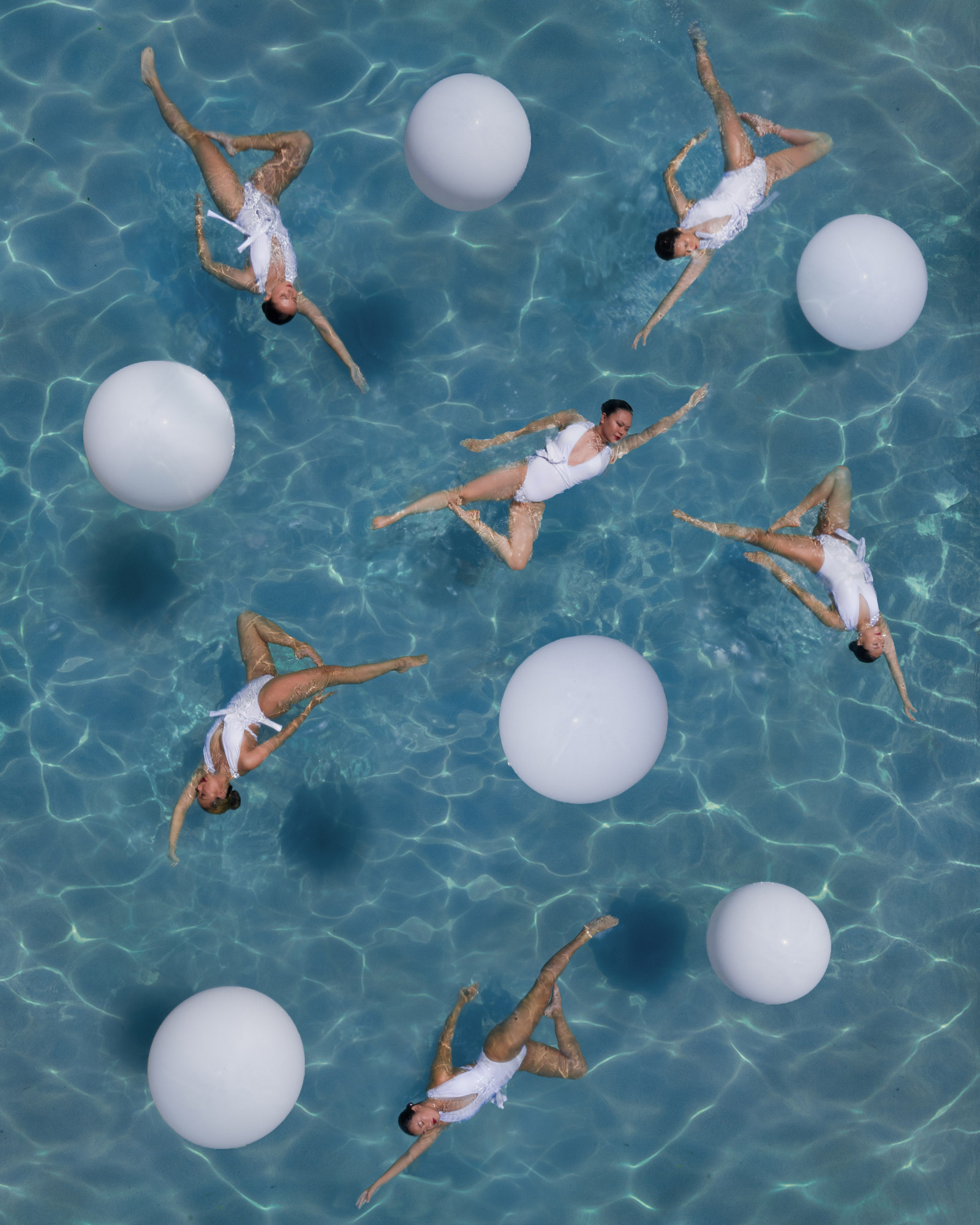 aerial shot of synchronised swimmers performing
