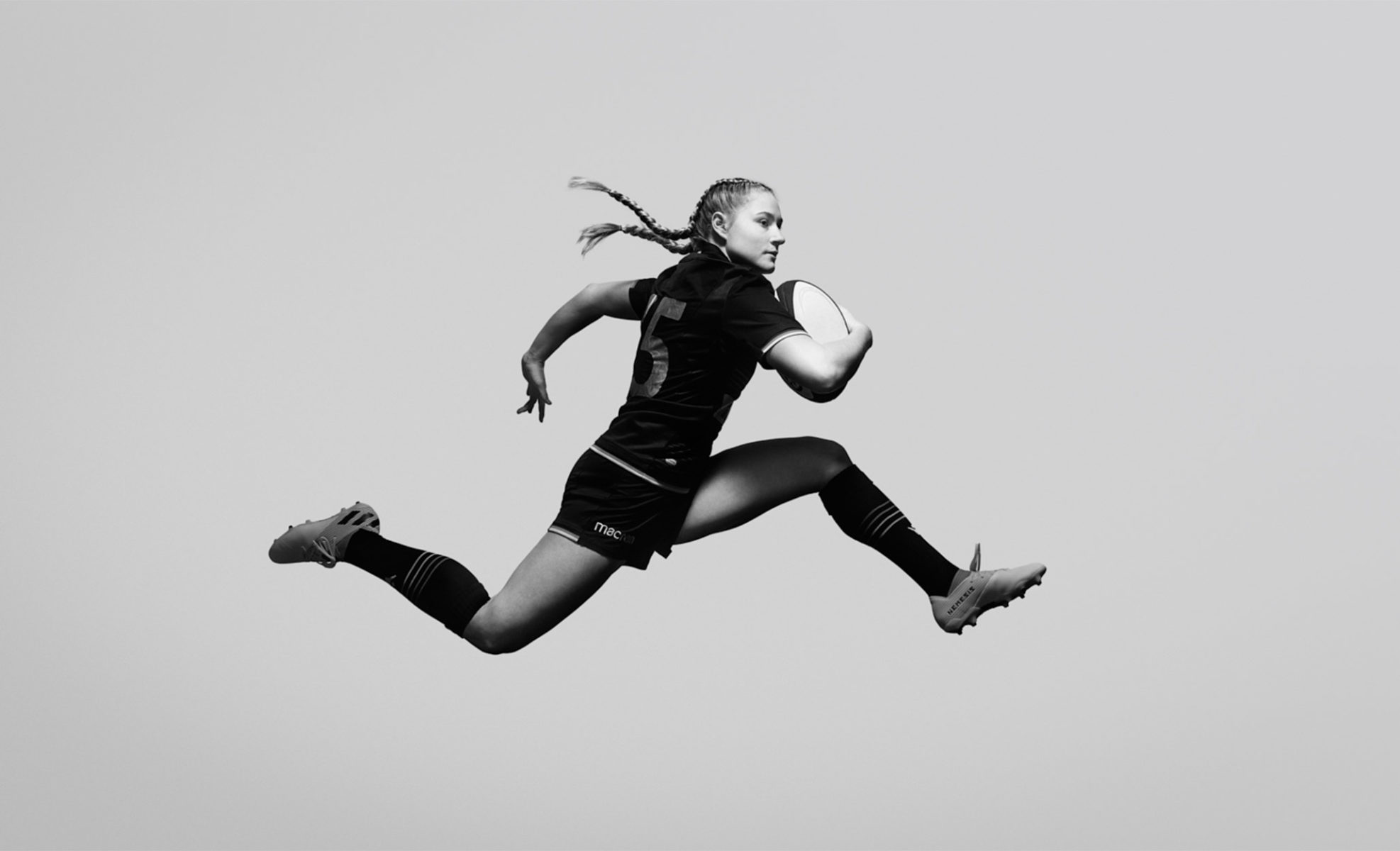 glorious fernando fath female rugby player leaping in the air in studio