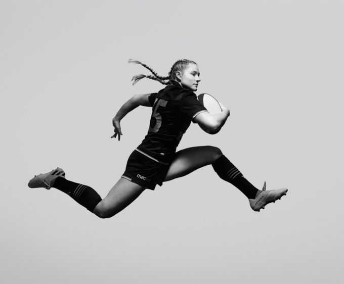glorious fernando fath female rugby player leaping in the air in studio